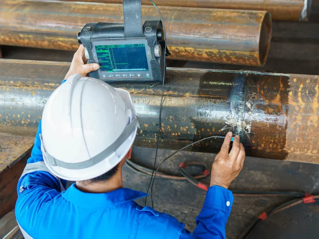Engineer carrying out non-destructive testing on pipework
